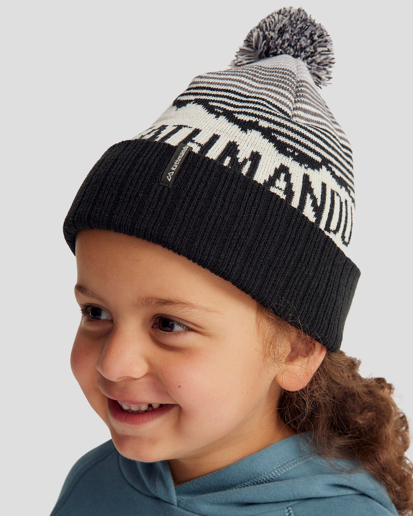 b0952_nzh_mtn_skies_kids_pompom_beanie_black_whit_c_1743628815000
